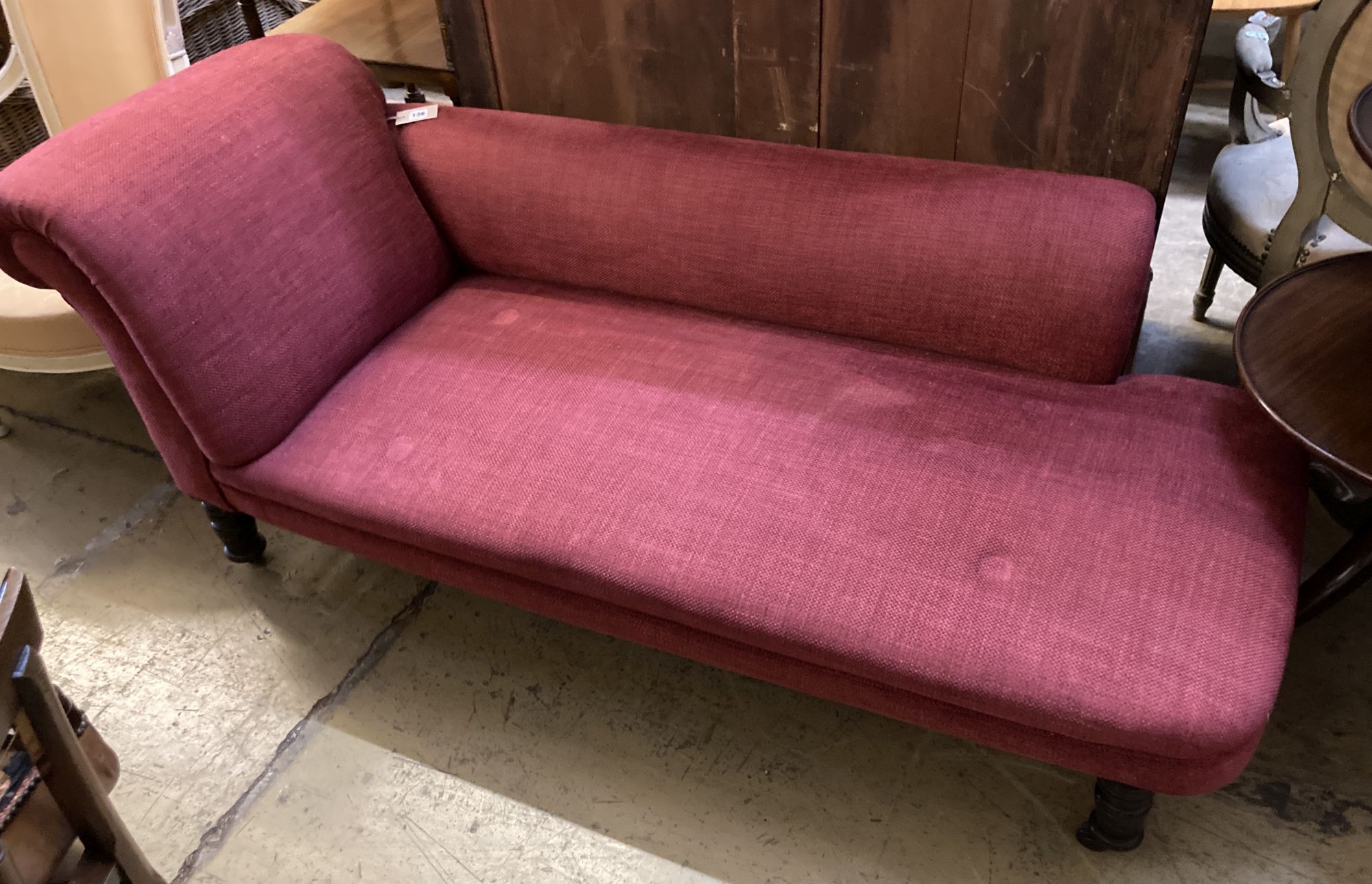 A late Victorian chaise longue, recently upholstered in red fabric, length 168cm, depth 70cm, height 74cm